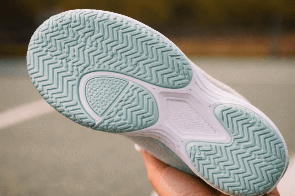 Close-up of herringbone outsole tread pattern on a women's pickleball shoe